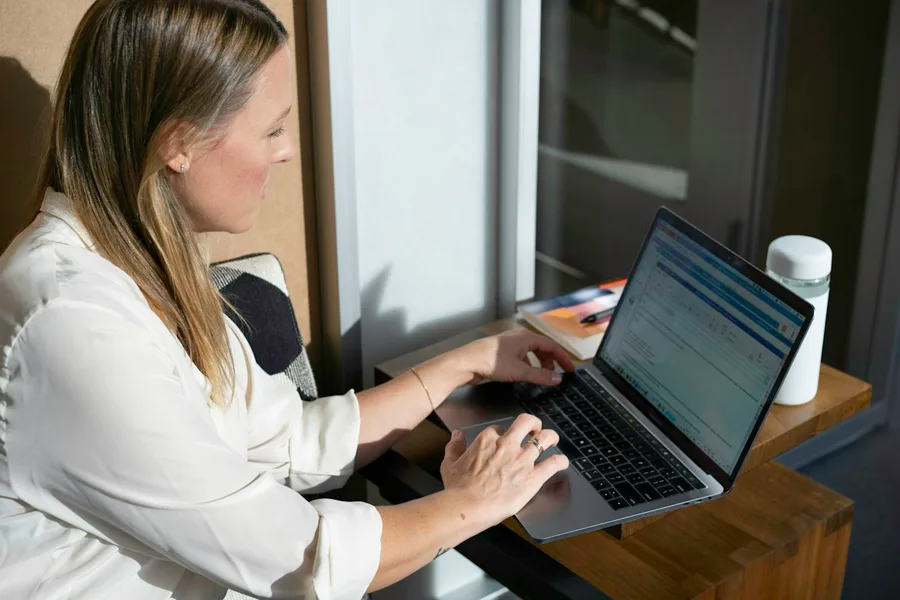 Professional working on business administration at a laptop